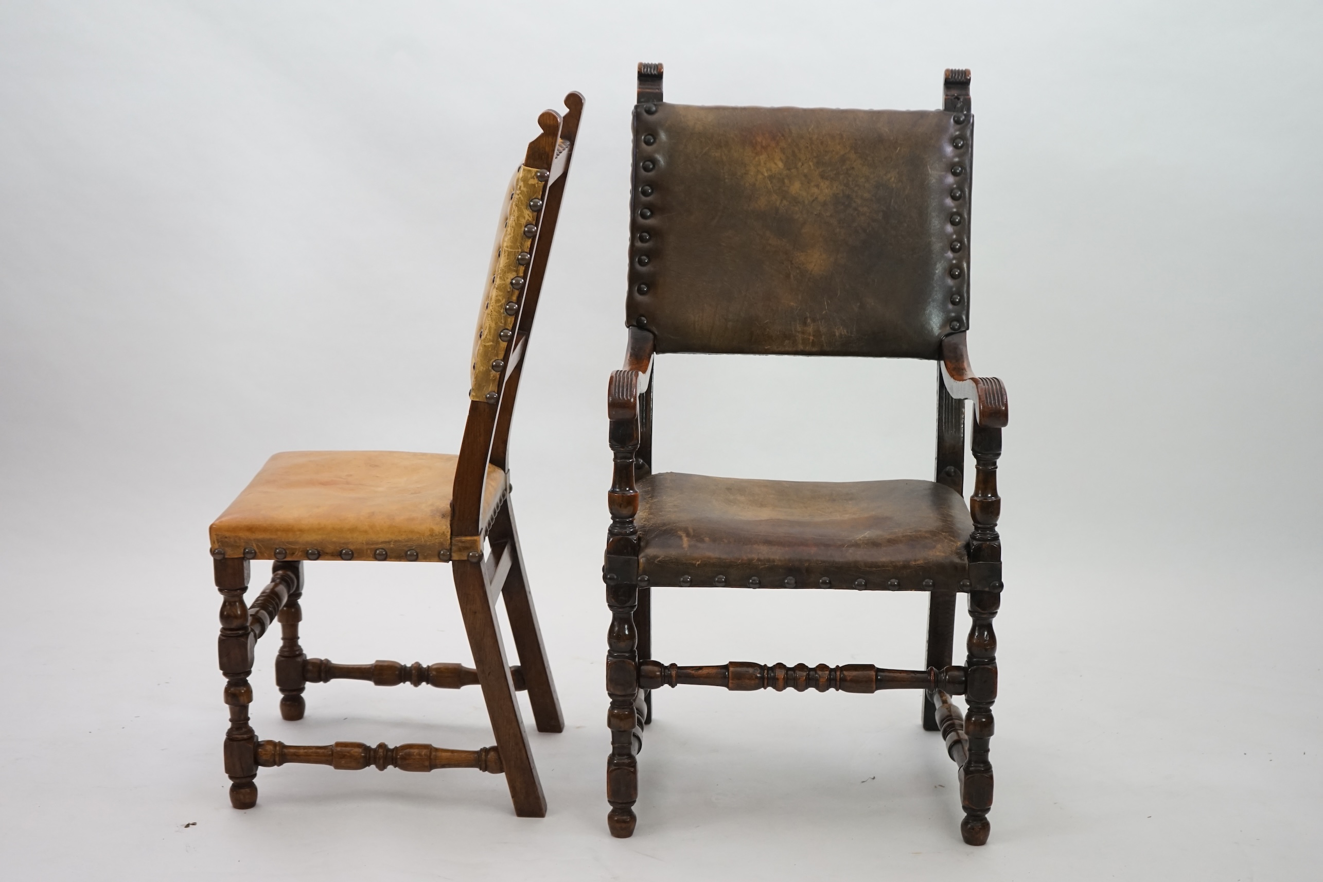 A set of fourteen 17th century style oak dining chairs including a pair of carvers